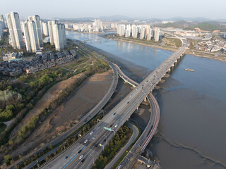 Cars and buildings running on a bridge
