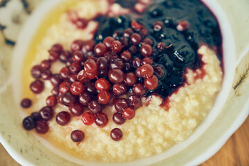 Wheat porridge for a healthy gluten-free breakfast. Warm wheat porridge with red currants and...