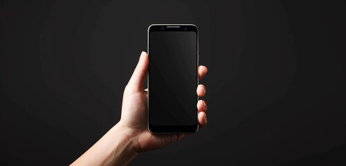The simplicity and sophistication of a hand holding a blank smartphone screen against a black background, creating a visually stunning and timeless composition. 