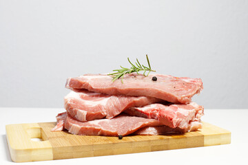 fresh raw pork meat, pork tenderloin steaks ready to be cooked in kitchen