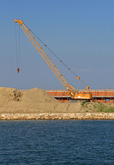 Yellow Crawler Boom Crane at Sea Wall Construction Site in Venice Italy