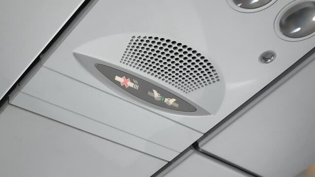 Seat belt sign notification inside the airplane cabin overhead for passenger safety