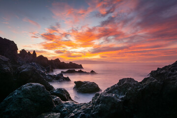 Beautiful landscape with a rocky beach at sunset