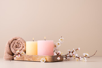 Burning candles and cherry blossom twig, spa, wellness still life