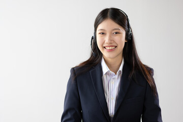 Smiling Asian businesswoman wearing headphones and microphon, headset.