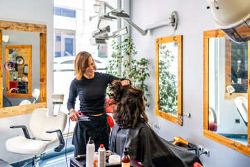 Hairdresser and woman in a beauty salon