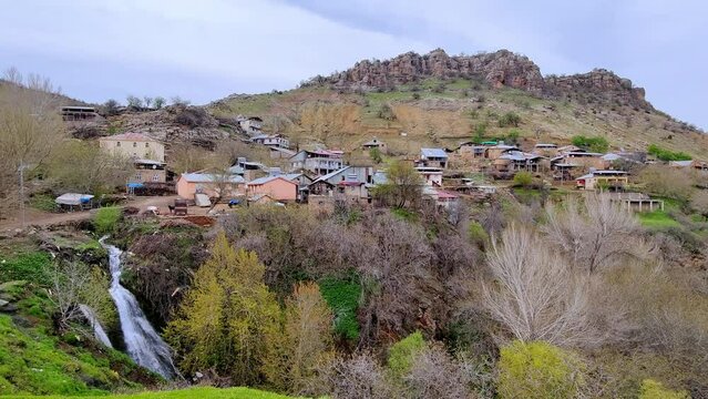 A village built at the foot of the mountain with a waterfall flowing through it. Harmacik Genc Bingol