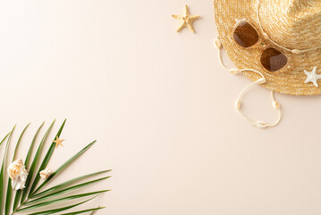 Soak up the sun: top view of straw hat, sunglasses, palm leaf, shells, and starfishes on a calm...