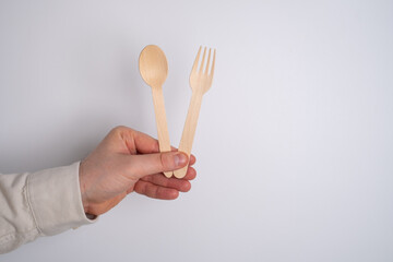 Wooden spoon and fork, a set of kitchen utensils on a white background. Zero waste concept, less...