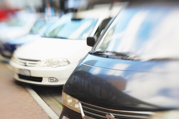 Car park, order with blurred background and transportation in city, stationary vehicle or...
