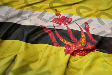 waving colorful national flag of brunei on a euro money banknotes background. finance concept.