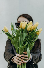 Girl with tulips in her hands.