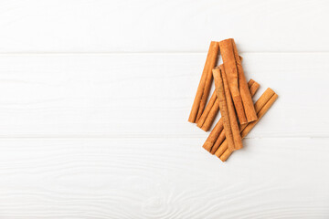 Cinnamon sticks on a textured wooden background. Cinnamon roll. Spicy spice for baking, desserts and drinks. Fragrant ground cinnamon. cinnamon powder Close-up. Place for text. copy space