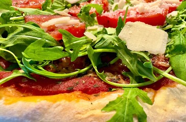 Tomato, arugula and parmesan as a topping on a pizza, rocket, mozzarella, pizzeria, restaurant,...
