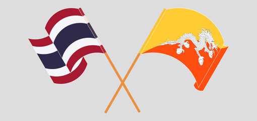 Crossed and waving flags of Thailand and Bhutan