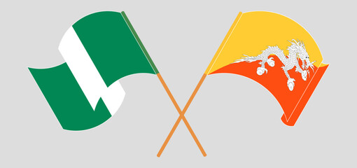 Crossed and waving flags of Nigeria and Bhutan