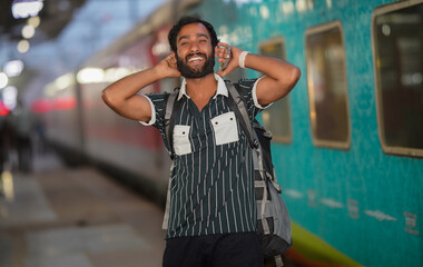 Happy traveler boy excited near railway station, waiting for the train