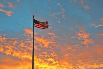 American flag on a flagpole against a sunrise sky