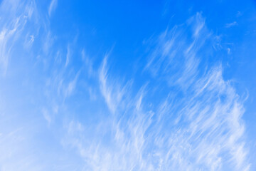 White clouds in blue sky on a windy day, natural background texture - obrazy, fototapety, plakaty