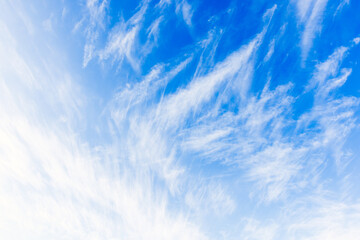 White cirrus clouds are in blue sky, natural background photo texture - obrazy, fototapety, plakaty