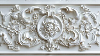 White ornamental plasterwork detail with floral pattern.
