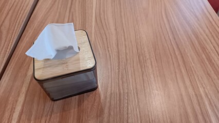 Portrait of a tissue box container on a wooden table