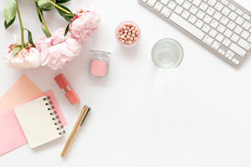 White working office table background with peony flowers and female accessories