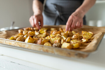 Fresh roasted and chopped potatoes on a baking sheet