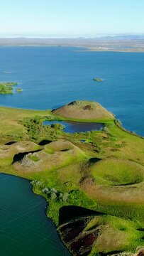 Aerial vertical video of pseudo craters over water in Iceland.