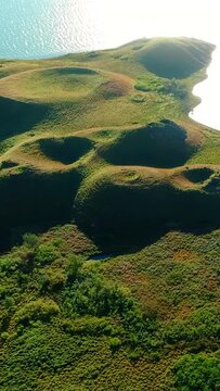 Green rootless cones in an aerial vertical video in Iceland.