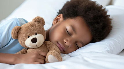 Little boy sleeping with his teddy bear.