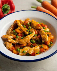 Chicken strips sautéed with peppers, peas, onion and carrot.