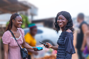 Two Young African Women Using NFC Payment Method