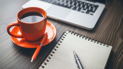 Close-up of a coffee cup beside a notepad and pen, symbolizing the perfect brainstorming session in a well-equipped workspace.
