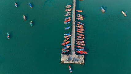 Aerial view of Bridge with long tail boats and beautiful crystal clear water in summer.