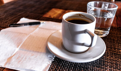 Cup of coffee with notepad and ballpoint pen on table Mexico.