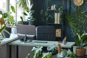 Background image of office workplace decorated with lush green plants copy space 