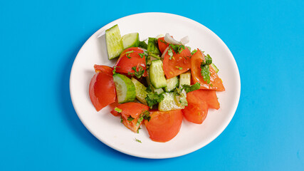 Tomato cucumber salad plate top view