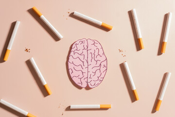 Smoking harms brain health. Tobacco or cigarettes with human brain organ symbol on brown...