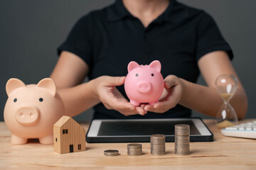  concept of saving money. A woman holding a piggy bank represents saving money to invest in the...