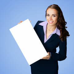 Happy smile woman in black confident suit, peep out holding blank white paper signboard poster with empty sign text area. Business ad concept. Isolated against blue background. Square.