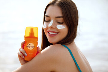 Woman smile applying sun cream on face. Skincare. Body Sun protection. sunscreen. Female smear moisturizing lotion on skin.