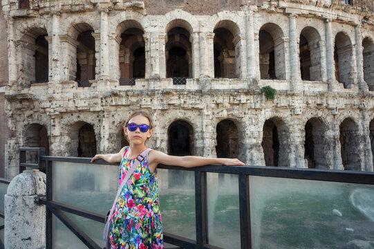 Girl in front of the ancient facade of open-air Theatre of Marcellus (Teatro di Marcello) in sunny day, Rome, Italy