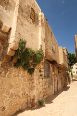 A row of traditional houses next to a small alleyway in the old town of Mardin, Turkey