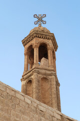 Fototapeta na wymiar The bell tower of the Mor Smuni Church, Kilisesi, syriac orthodox church in Mardin, Turkey