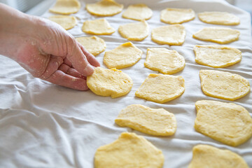Wife woman mom preparing homemade pasta pastry noodles  in domestic kitchen on white cloth. Minimal...