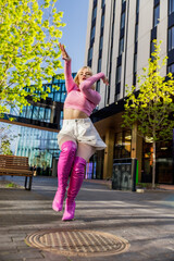 Vertical Screen: Beautiful And Fashionable Young Caucasian Woman Wearing Pink Outfit And Voguing On City Street. Vogue Dancer Practicing Her Choreography During The Day. Preparing For The Vogue Ball.