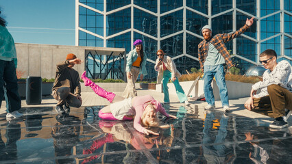 Vibrant Outdoor Scene Of Young Adults Energetically Dancing On A Glossy Urban Plaza, Reflecting The...