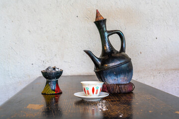 Ethiopia, traditional made coffee is served in a coffee pot  and with burning incense.