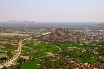 Aerial view of the city Bypass road and a fort on a hill top in Tamil Nadu 